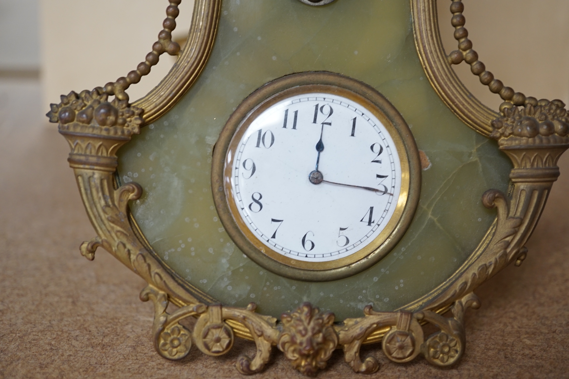 An onyx and gilt metal easel timepiece and thermometer, 20cm high. Condition - fair